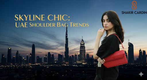 A young woman holding a red leather shoulder bag poses in the foreground of a scenic Dubai city skyline at dusk. The text "SKYLINE CHIC: UAE SHOULDER BAG TRENDS" is overlaid in gold font. The logo for "SHAKIR CARDINO" is in the top right corner.